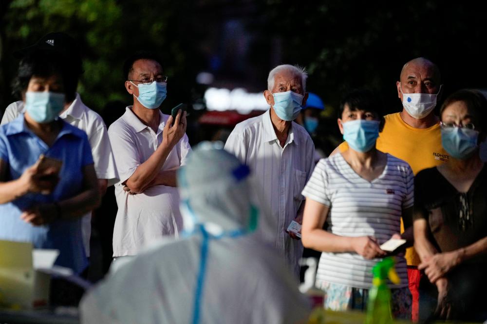 People line up to get tested for the coronavirus disease (COVID-19) at a nucleic acid testing site at a residential area, following the COVID-19 outbreak, in Shanghai, China July 19, 2022. - REUTERSPIX