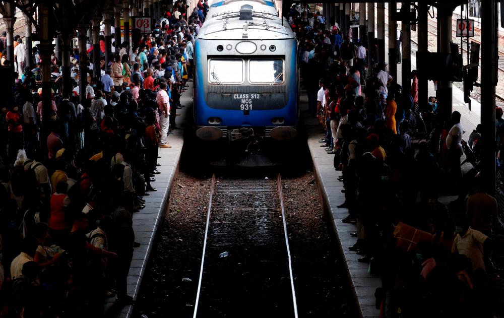 Passengers wait for a train at a crowded staton as public transportation gets limited fuel amid Sri Lanka's economic crisis, in Colombo, Sri Lanka, July 30, 2022. REUTERSPIX