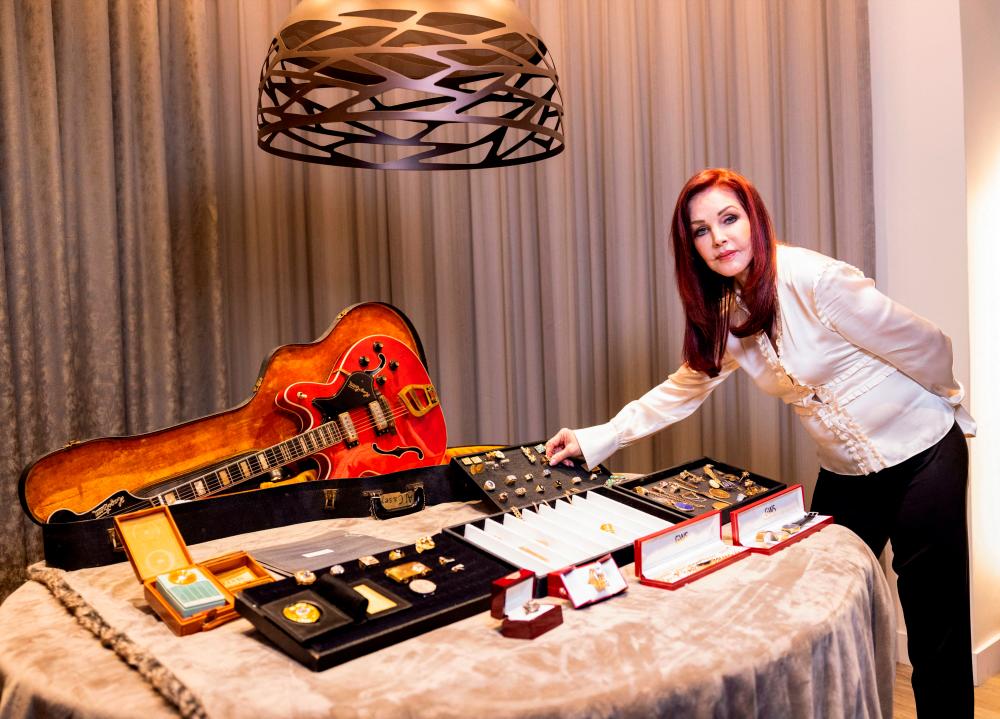 Priscilla Presley looks at a collection of personal jewelry of Elvis Presley &amp; Colonel Tom Parker, that was lost for decades and will be sold at auction in August, at the Sunset Marquis Hotel, in Hollywood, California/AFPPix