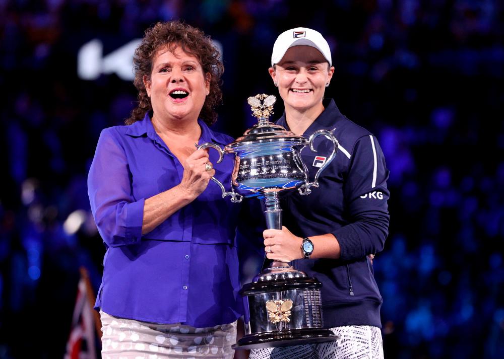 FILE PHOTO: Tennis - Australian Open - Women’s Singles Final - Melbourne Park, Melbourne, Australia - January 29, 2022 Australia’s Ashleigh Barty celebrates as she holds the trophy while she poses with former Australian Open champion Evonne Goolagong Cawley after she won the final against Danielle Collins of the U.S. REUTERSpix