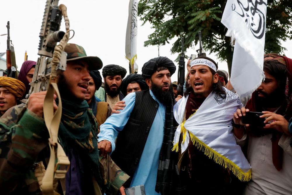 Taliban fighters celebrate the first anniversary of the fall of Kabul on a street in Kabul, Afghanistan, August 15, 2022. - REUTERSPIX