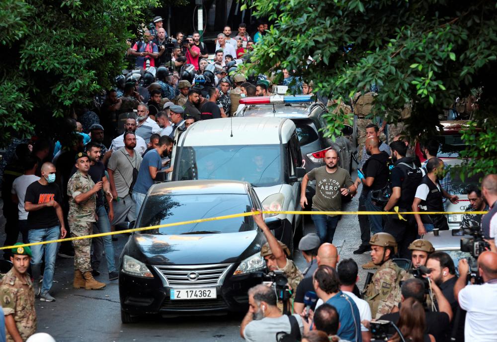 FILE PHOTO: Vehicles are seen outside the Federal bank of Lebanon, after people who were held hostages exited the bank, in Hamra, Lebanon, August 11, 2022. - REUTERSPIX