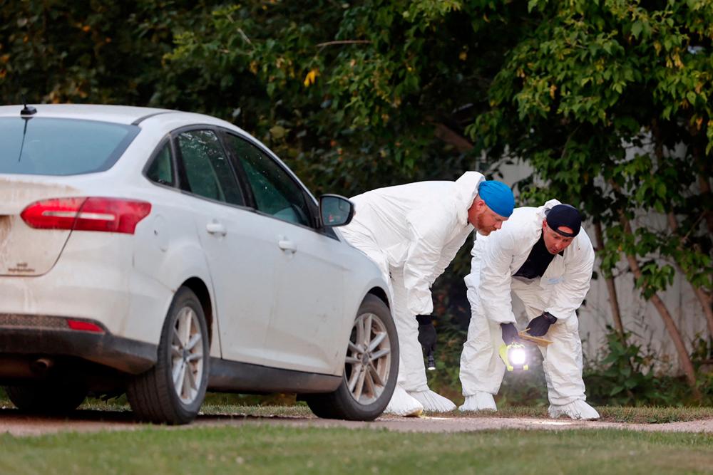 A police forensics team investigates a crime scene after multiple people were killed and injured in a stabbing spree in Weldon, Saskatchewan, Canada. September 4, 2022. - REUTERSPIX