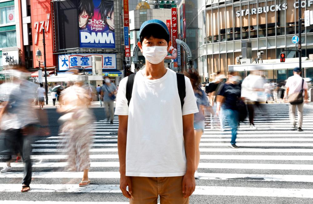 Shoji Morimoto who charges 10,000 yen ($71.30) an hour to accompany clients and simply exist as a companion, poses at Shibuya crossing in Tokyo, Japan August 31, 2022. REUTERSPIX