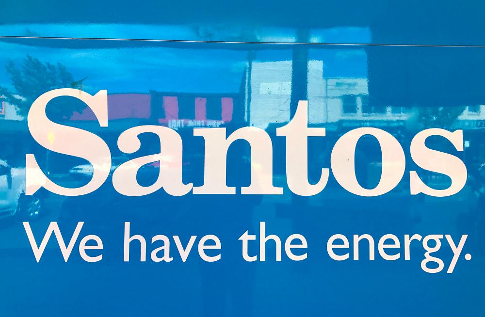 FILE PHOTO: A sign for Santos Ltd is displayed on the front of the company's office building in the rural township of Gunnedah, located in north-western New South Wales in Australia, March 9, 2018. Picture taken March 9, 2018. - REUTERSPIX