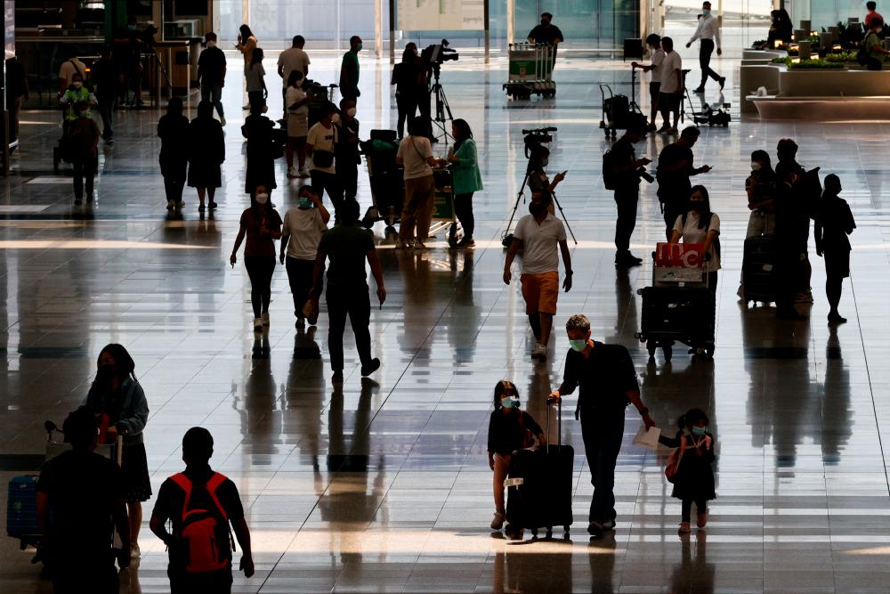 Travellers arrive at the Hong Kong International Airport on the first day the Covid hotel quarantine has been scrapped, in Hong Kong, China September 26, 2022. REUTERSpix