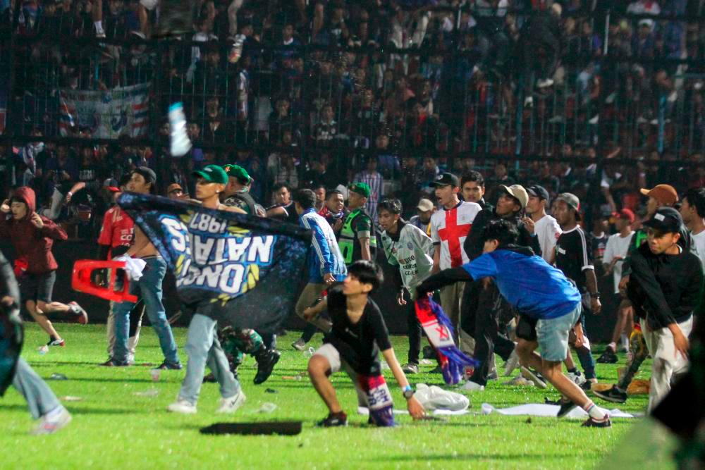 Filepix: Arema FC supporters enter the field after the team they support lose to Persebaya after football match at Kanjuruhan Stadium, Malang/REUTERSPix
