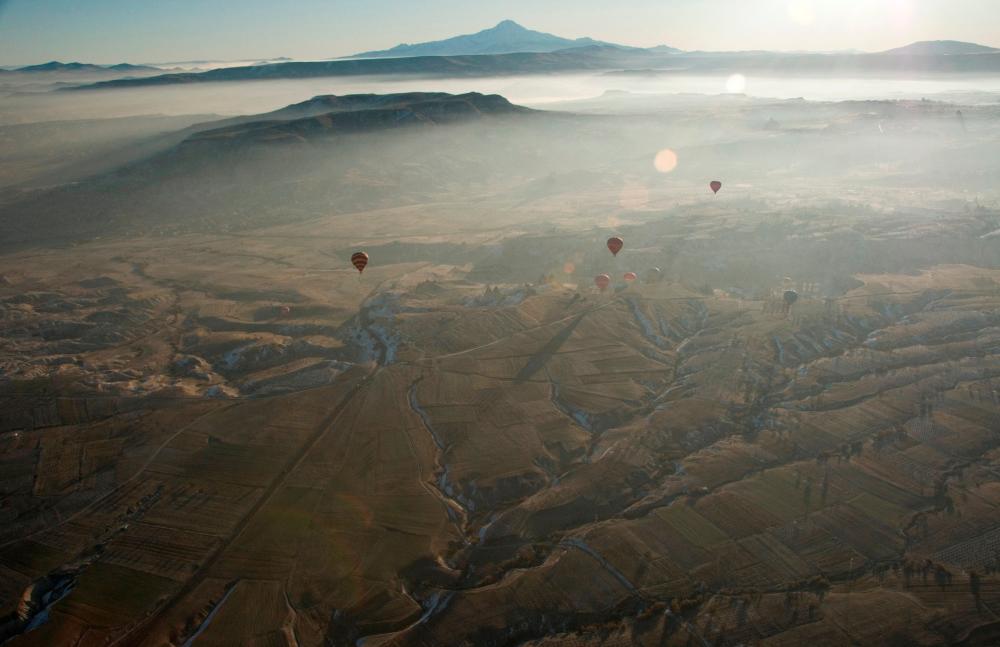 Hot air balloons are seen over Cappadocia December 12, 2008. Cappadocia is a popular tourist destination in Turkey renowned for unusual rock formations and rock-caved churches. Picture taken December 12, 2008. REUTERSPIX