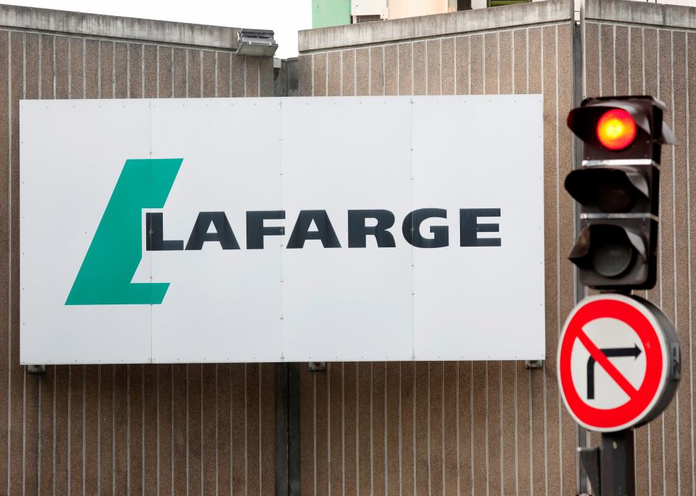 FILE PHOTO: The logo of French concrete maker Lafarge is seen on the plant of Bercy on the banks of the river Seine in Paris, France, September 3, 2020. - REUTERSPIX
