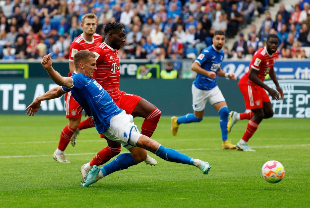 Soccer Football - Bundesliga - TSG 1899 Hoffenheim v Bayern Munich - PreZero Arena, Sinsheim, Germany - October 22, 2022 TSG 1899 Hoffenheim’s Grischa Promel in action with Bayern Munich’s Alphonso Davies REUTERSpix