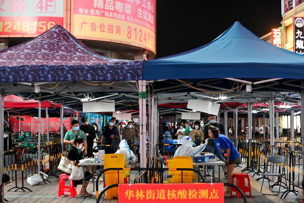 People line up to take nucleic acid test for the coronavirus disease (COVID-19) following the outbreak, at a makeshift testing site in Guangzhou, Guangdong province, China November 9, 2022. REUTERSPIX