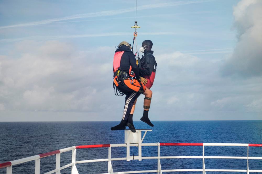 French authorities lift a migrant who needs urgent hospital care, to the helicopter from rescue ship ‘Ocean Viking’ in the Mediterranean Sea/AFPPix