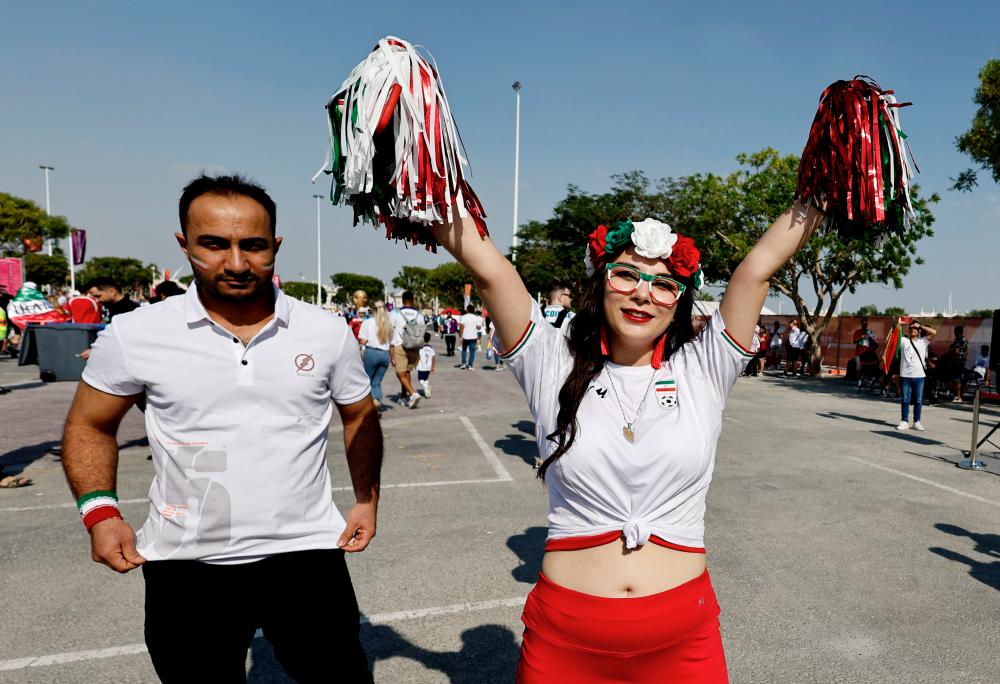 $!Iran fans outside the stadium. – REUTERSPIX