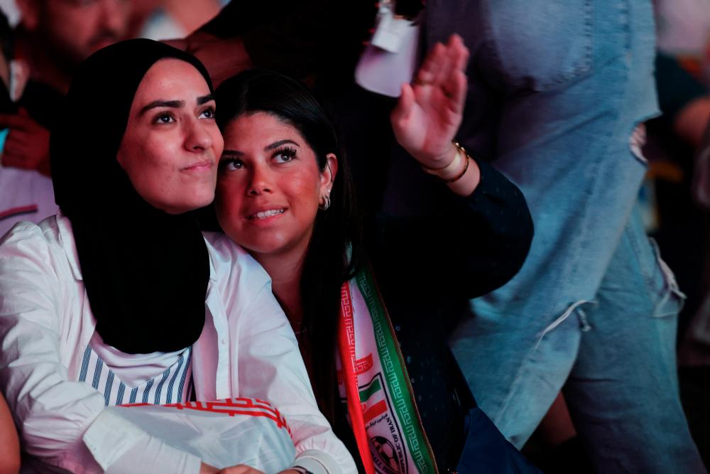 $!Iran fans are seen during the match between England and Iran. – REUTERSPIX