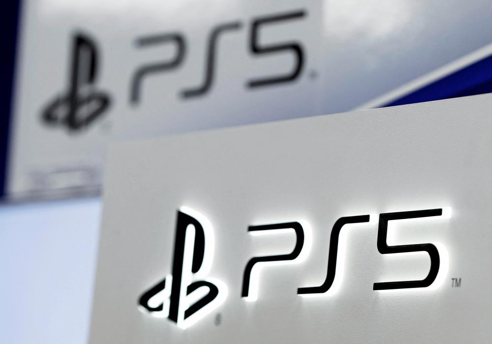 FILE PHOTO: The logos of Sony's PlayStation 5 are displayed at the consumer electronics retailer chain Bic Camera, ahead of its official launch, in Tokyo, Japan November 10, 2020. REUTERS/Issei Kato//File Photo