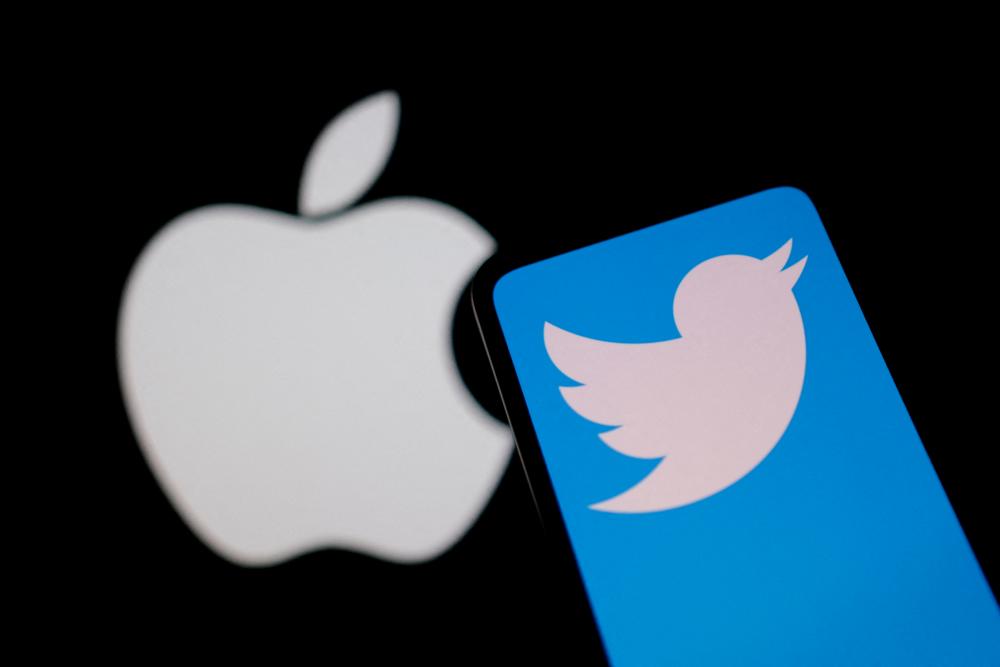 Smartphone with displayed Twitter logo is seen in front of Apple logo in this illustration taken, November 29, 2022. REUTERSPIX