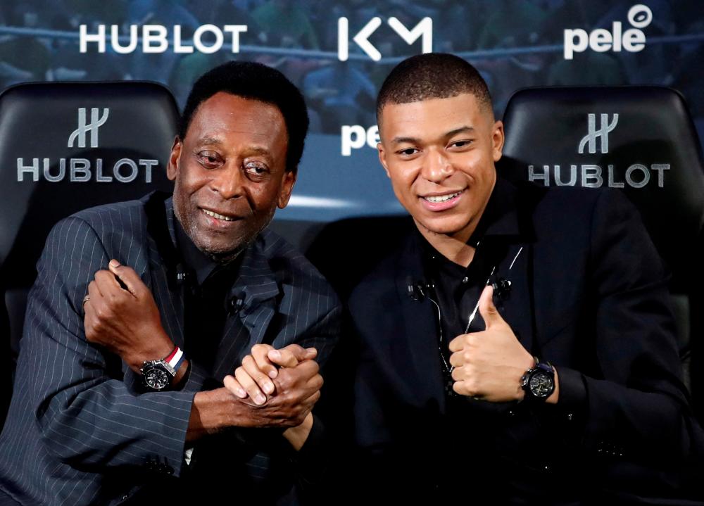 FILE PHOTO: French soccer player Kylian Mbappe and Brazilian soccer legend Pele pose ahead of their meeting in Paris, France April 2, 2019. - REUTERSPIX