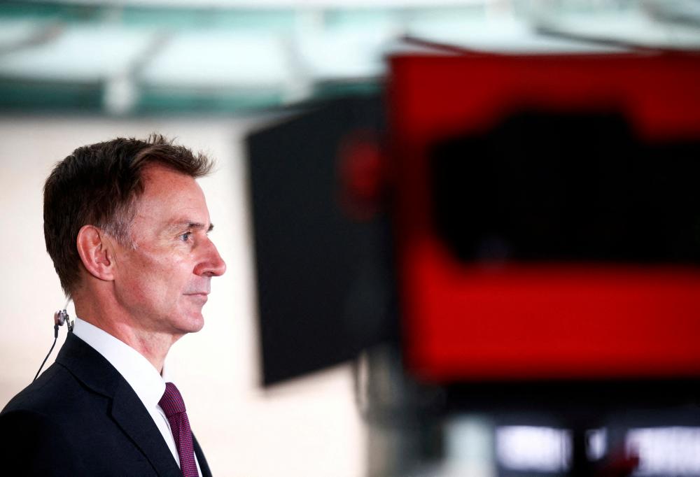 British Chancellor of the Exchequer Jeremy Hunt talks to a television crew outside the BBC headquarters in London, Britain November 18, 2022. REUTERSpix