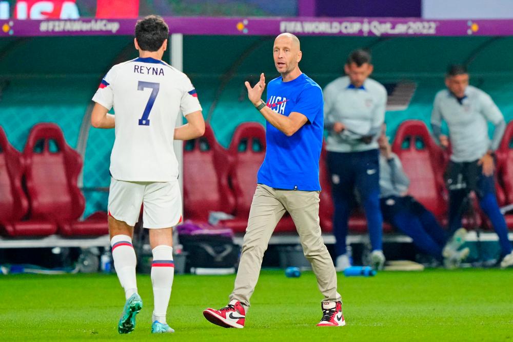 FILE PHOTO: Dec 3, 2022; Al Rayyan, Qatar; United States of America manager Gregg Berhalter talks with midfielder Giovanni Reyna (7) against the Netherlands during the second half of a round of sixteen match in the 2022 FIFA World Cup at Khalifa International Stadium/REUTERSPix