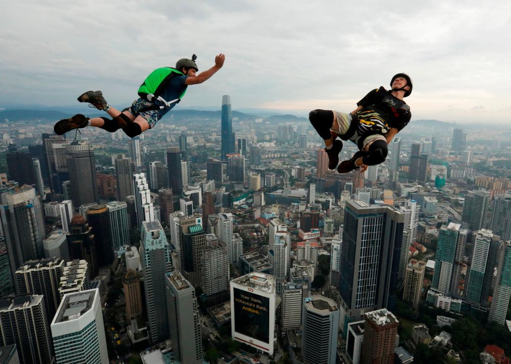 Base jumpers leap off the Kuala Lumpur Tower during the annual KL Tower International Jump Malaysia 2023 at Kuala Lumpur, Malaysia, February 3, 2023. REUTERSpix