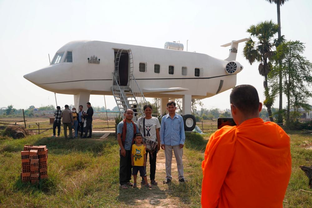 Visitors take pictures in front of the “airplane house” built by Chrach Pov in Siem Reap province, Cambodia, February 2, 2023/REUTERSPix
