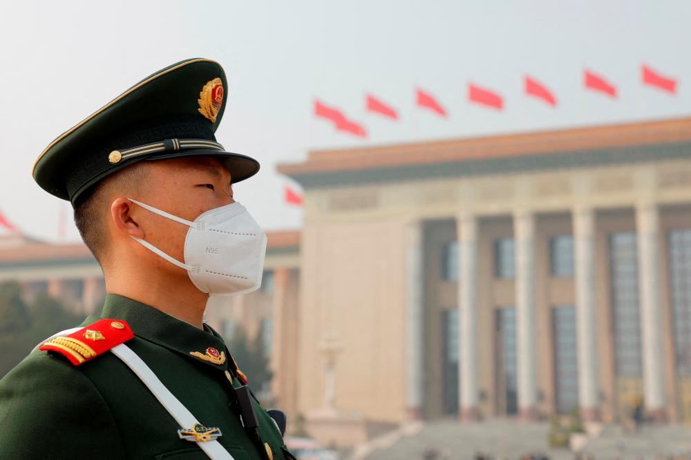 A paramilitary police officer stands guard outside the Great Hall of the People following the opening session of the National People’s Congress (NPC), on a polluted day in Beijing, China March 5, 2023. REUTERSPIX