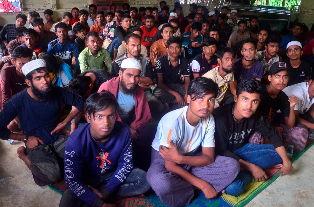 Rohingya refugees sit inside a temporary shelter after they landed in Kuala Matang Peulawi, East Aceh, Aceh province, Indonesia, March 27, 2023. REUTERSPIX