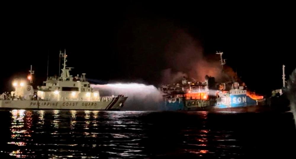Philippine Coast Guard respond to the fire incident onboard M/V LADY MARY JOY 3 at the waters off Baluk-Baluk Island, Hadji Muhtamad, Basilan, Philippines, March 29, 2023. REUTERSPIX