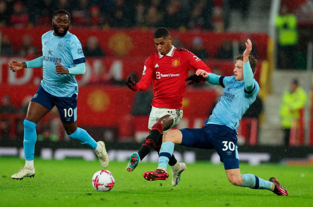 Football - Premier League - Manchester United v Brentford - Old Trafford, Manchester, Britain - April 5, 2023 Manchester United’s Marcus Rashford in action with Brentford’s Mads Roerslev and Josh Dasilva. REUTERSpix