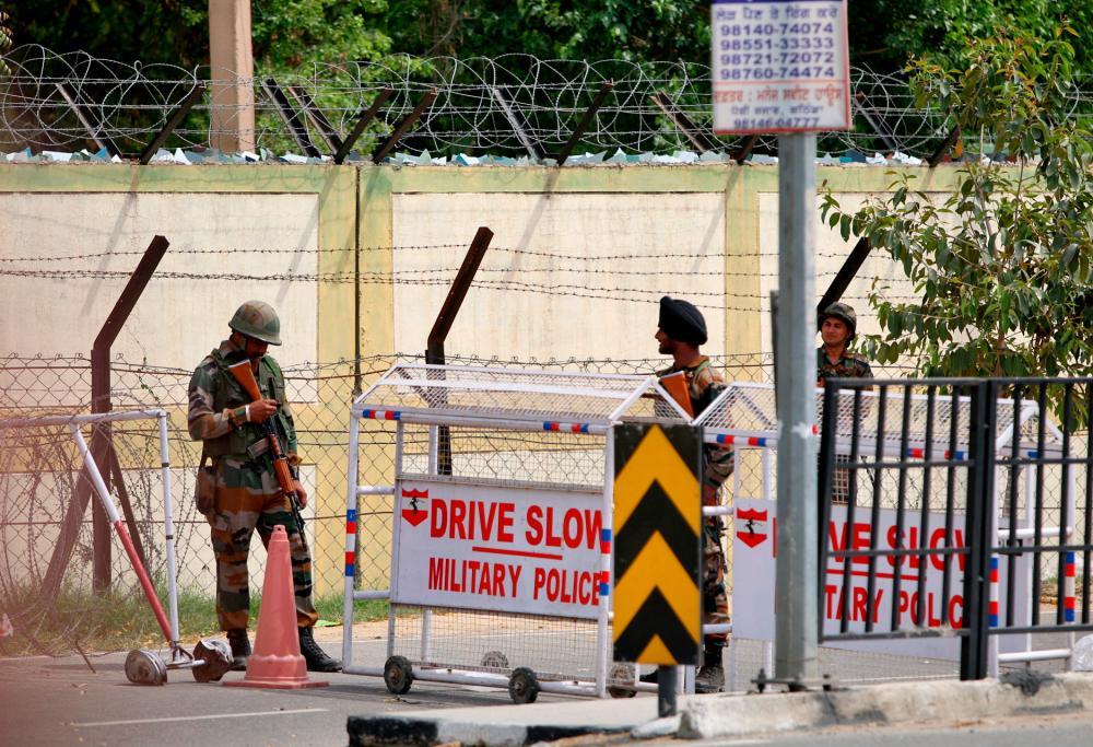 Indian army soldiers stand next to a barricade outside a military base, after a firing incident in Bathinda, India, April 12, 2023. REUTERSPIX