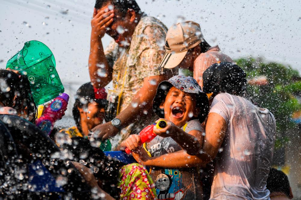 Local people play with water as they celebrate the Songkran holiday which marks the Thai New Year in Bangkok, Thailand, April 14, 2023. REUTERSPIX