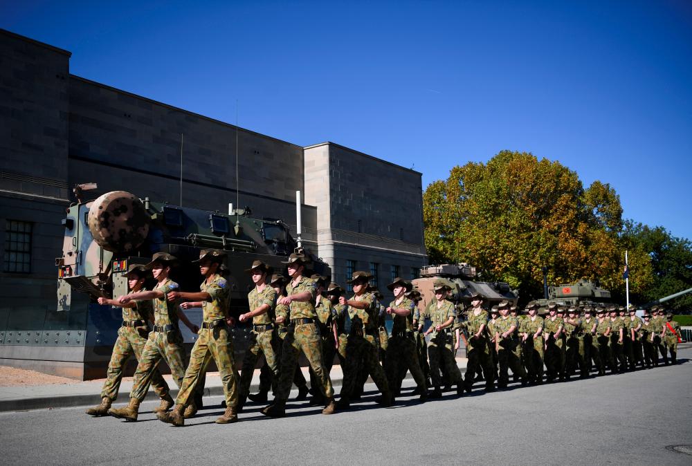 Army personnel march in the ANZAC Day Parade on ANZAC Day at the Australian War Memorial, Canberra, Australia//Reuters