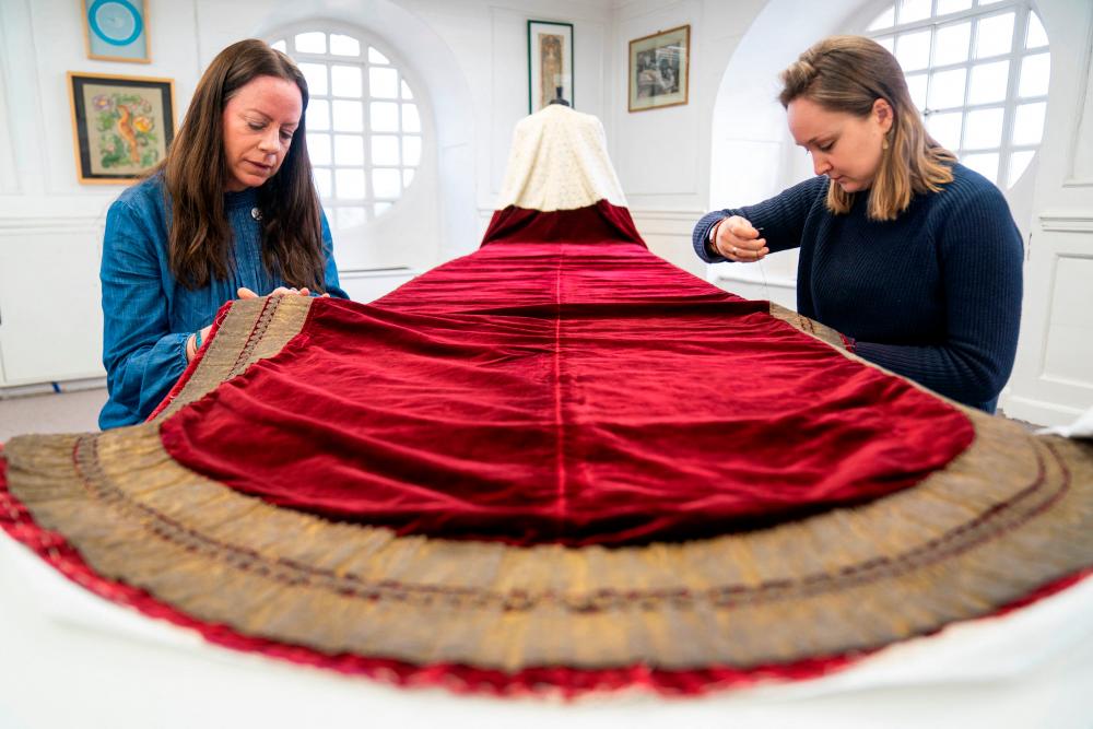 Work is carried out on Britain’s King Charles’s Robe of State, which he will wear at his coronation on May 6, by members of the Royal School of Needlework, at Hampton Court Palace, in East Molesey, Britain, February 27, 2023. REUTERSPIX