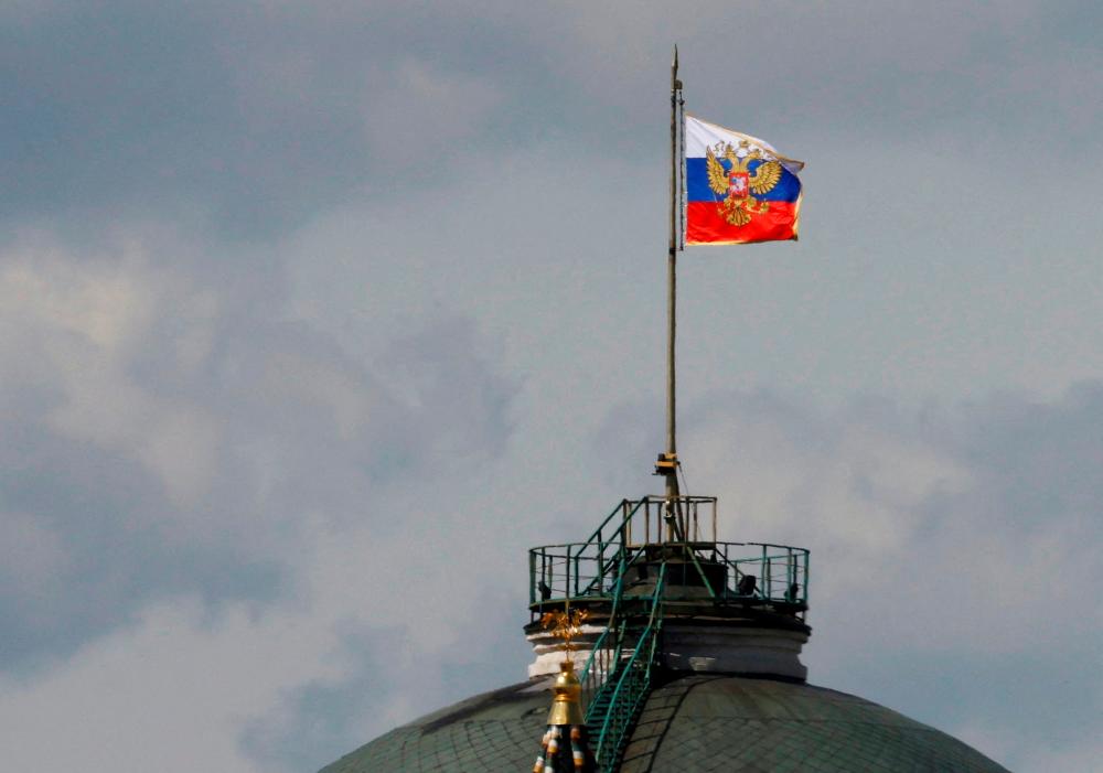 The Russian flag flies on the dome of the Kremlin Senate building, while the roof shows what appears to be marks from the recent drone incident, in central Moscow, Russia, May 4, 2023. REUTERSPIX