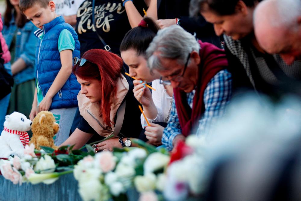 People light up candles to pay tribute for victims of Belgrade school mass shooting in Podgorica, Montenegro, May 5, 2023. REUTERSPIX