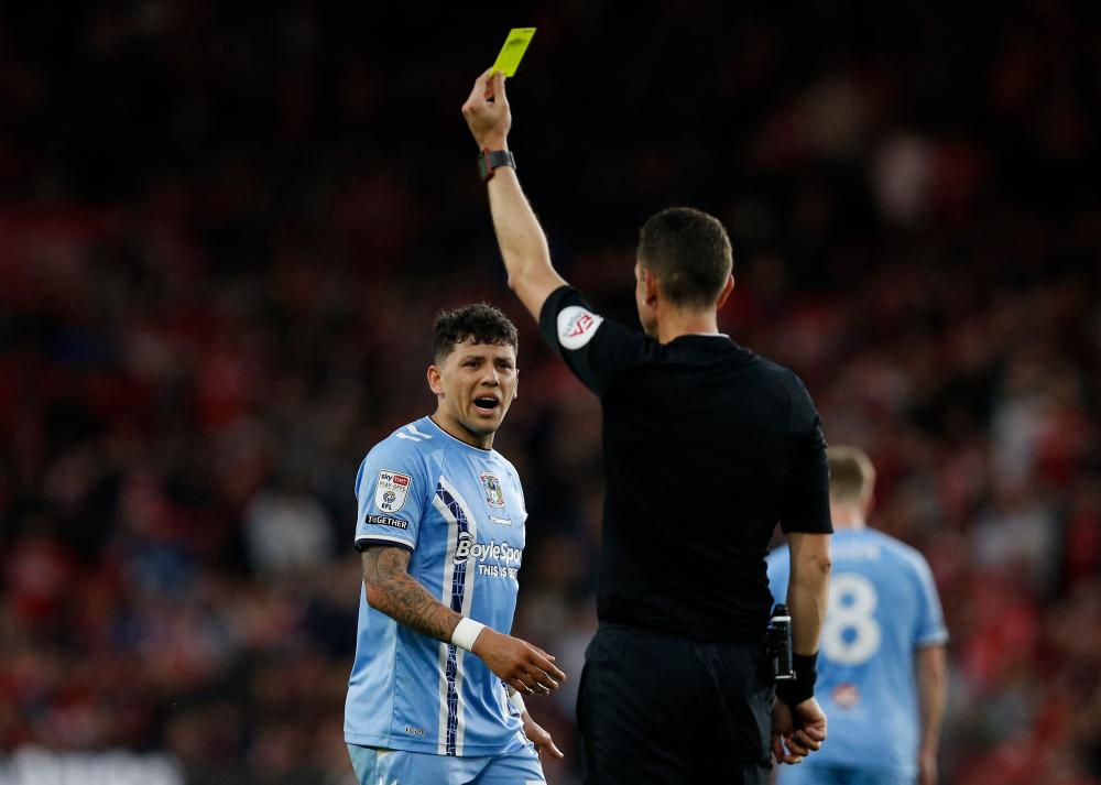 Coventry City’s Gustavo Hamer is shown a yellow card by referee David Coote/REUTERSPix