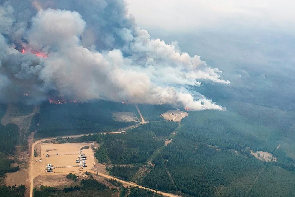 Smoke rises from areas on the southeast side of wildfire EWF-035, part of the Deep Creek Wildfire Complex which is being tackled by helicopters near Shining Bank, Alberta, Canada May 19, 2023. REUTERSPIX