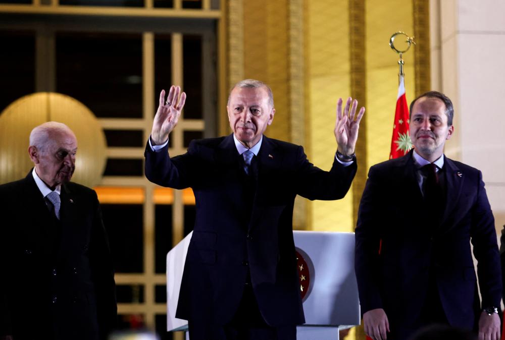 Turkish President Tayyip Erdogan, Devlet Bahceli, leader of Nationalist Movement Party (MHP), and New Welfare Party leader Fatih Erbakan greet Erdogan's supporters following his victory in the second round of the presidential election at the Presidential Palace in Ankara, Turkey May 29, 2023. - REUTERSPIX