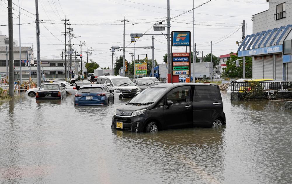 Vehicles submerged under water following heavy rain brought about by Typhoon Mawar are pictured in Toyokawa, Aichi Prefecture, central Japan in this photo taken by Kyodo on June 3, 2023. REUTERSPIX