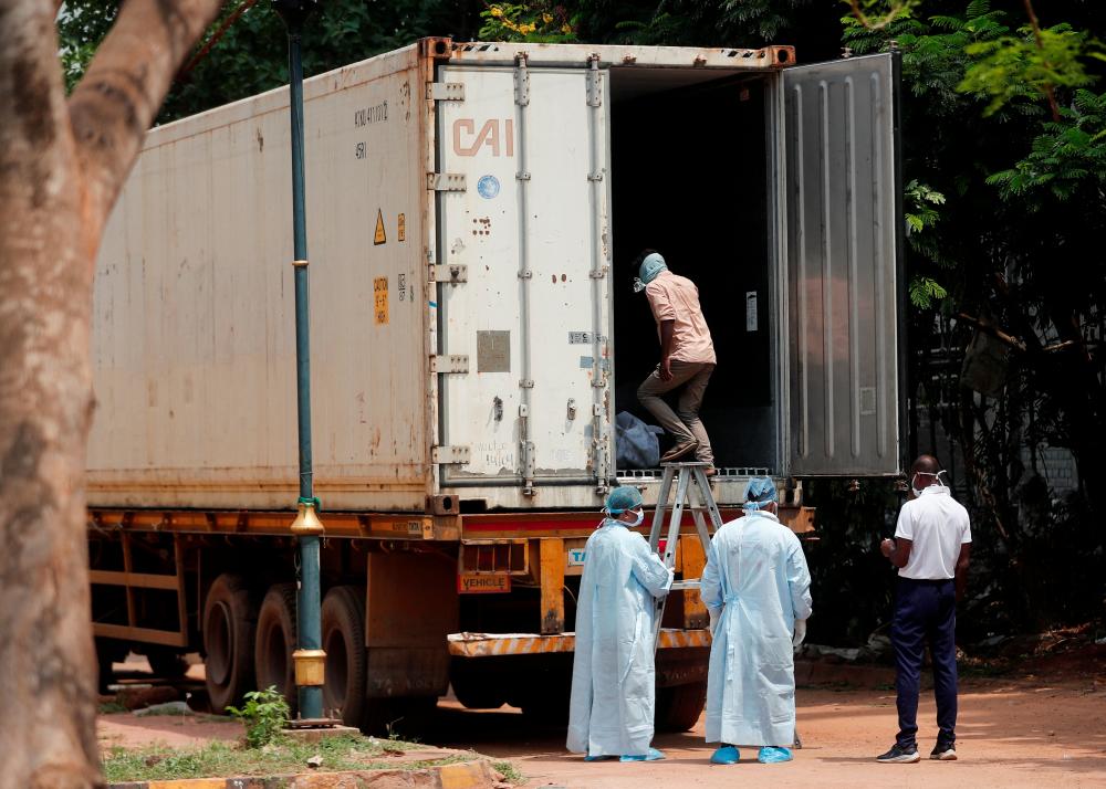A man enters a deep freezer truck filled with dead bodies to try and identify a family member killed after a multiple train collision in Balasore, at a hospital in Bhubaneswar in the eastern state of Odisha, India, June 6, 2023. - REUTERSPIX