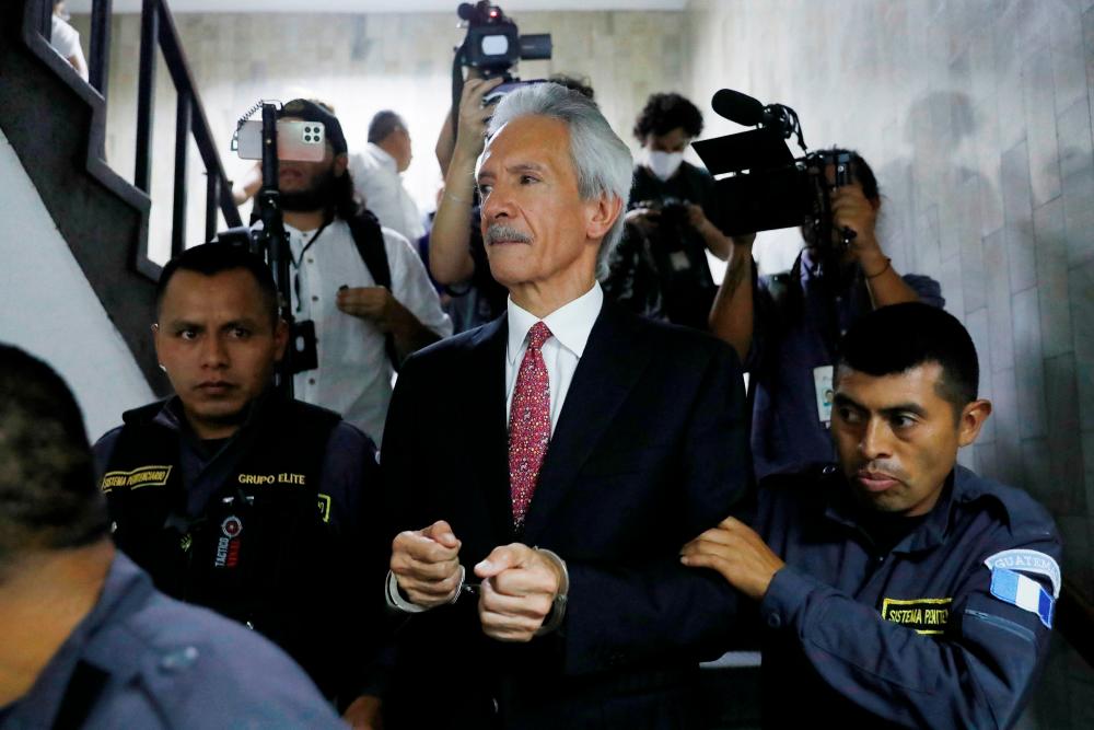 Journalist Jose Ruben Zamora Marroquin, founder and president of the newspaper elPeriodico, is escorted by police officers after being sentenced at a court in Guatemala City, Guatemala June 14, 2023/AFPPix