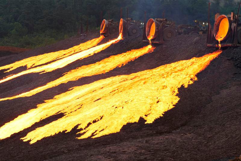 Hot slag flows from trucks to the dumping site at the nickel processing plant operated by PT Vale Indonesia in Sorowako, South Sulawesi province - REUTERSpix