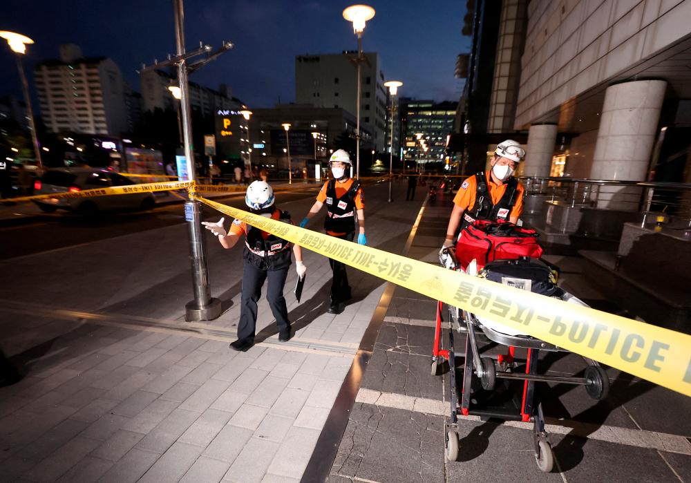 Rescue workers are seen at a scene where, according to media reports, nine people have been stabbed and four others hurt by a car driven by the suspected attacker in Seongnam, South Korea, August 3, 2023. AFPPIX