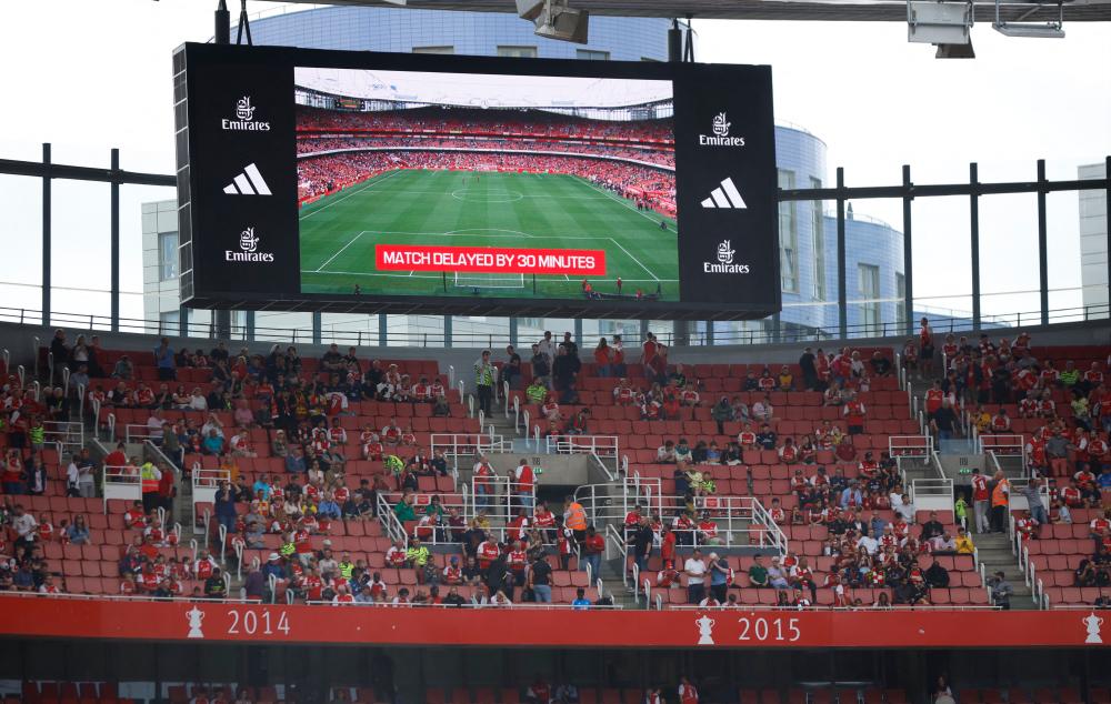 Premier League - Arsenal v Nottingham Forest - Emirates Stadium, London, Britain - August 12, 2023 General view of a big screen displaying a message that the match is delayed by 30 minutes. REUTERSpix