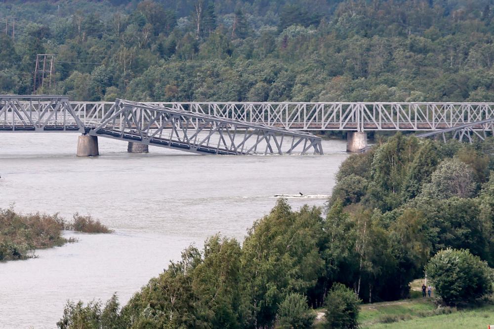 A collapsed railway bridge over the Gudbrandsdalslagen river is seen in Ringebu, Norway, August 14, 2023. REUTERSPIX