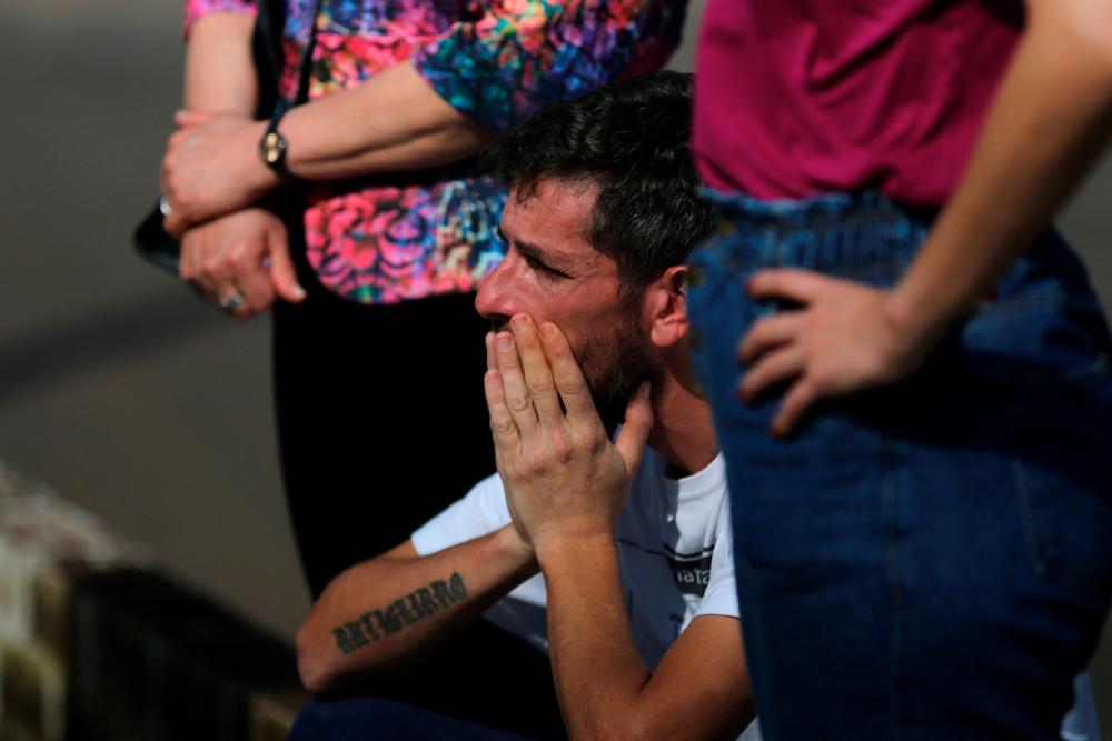 Flood survivor Miguel Rutigliano Bieleski cries during the funeral of his daughter Yasmin and his son Miguel Junior, fatal victims of the passage of the extratropical cyclone that hit the region, in Lajeado, Brazil September 11, 2023. -