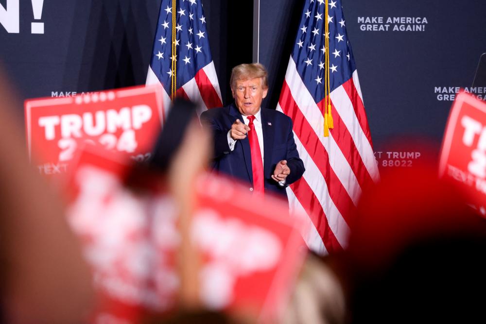 Former US President and Republican presidential candidate Donald Trump points at the supporters after speaking during a 2024 presidential campaign rally in Dubuque, Iowa, US September 20, 2023. REUTERSPIX
