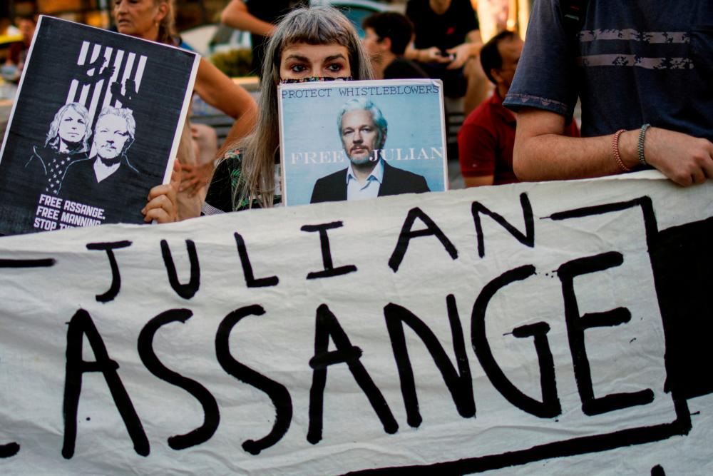 A supporter holds a poster depicting Julian Assange during a protest against the extradition of WikiLeaks’ founder from Britain to the U.S., in Athens, Greece, June 20, 2022. REUTERS