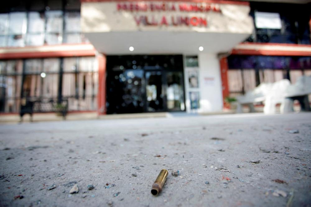 A spent bullet shell casing is pictured near the facade of the bullet-riddled town hall of Villa Union. REUTERSPIX