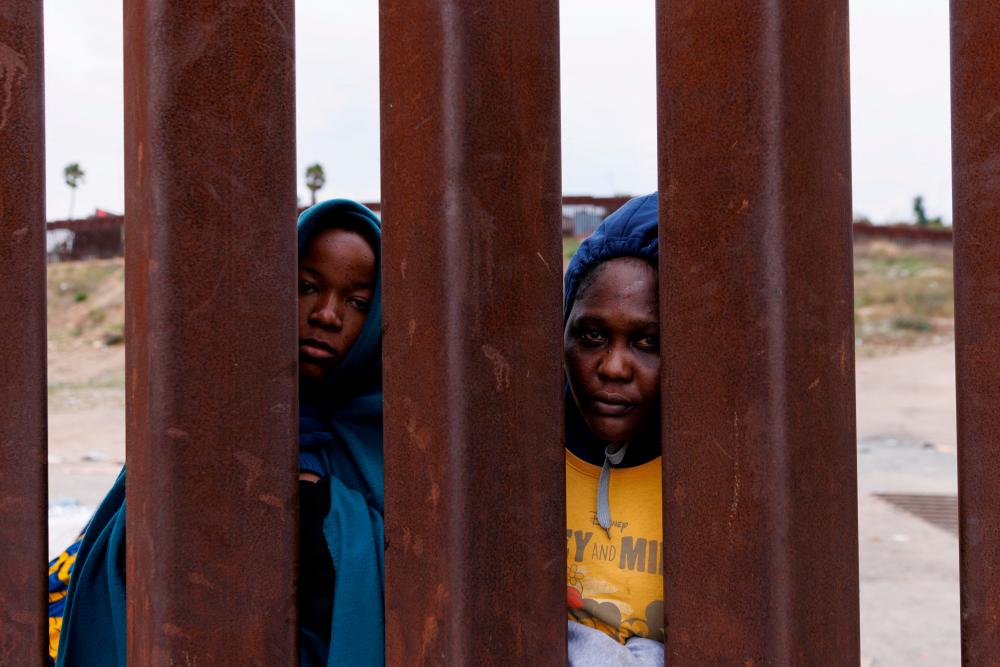 Migrants from Cameroon gather between the primary and secondary border fences between Mexico and the United States as they await processing by U.S. immigration in San Diego, California, U.S., September 22, 2023. REUTERSPIX